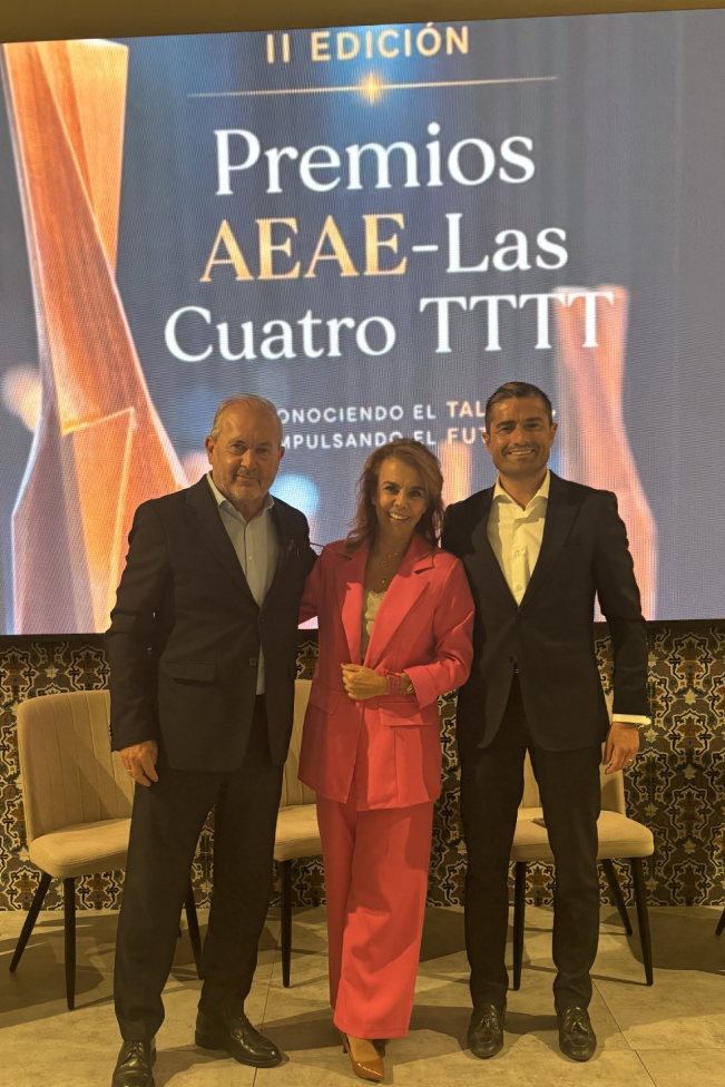 Tres asistentes posan ante el cartel de la II Edici&oacute;n de los Premios AEAE - Las Cuatro TTTT